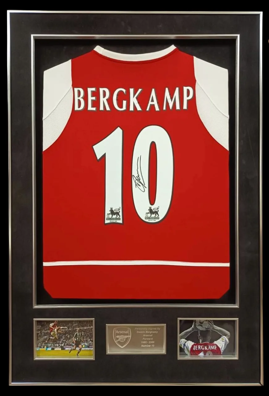 Dennis Bergkamp — signed Arsenal shirt (brown mount, gold frame) — authentic signed memorabilia, framed