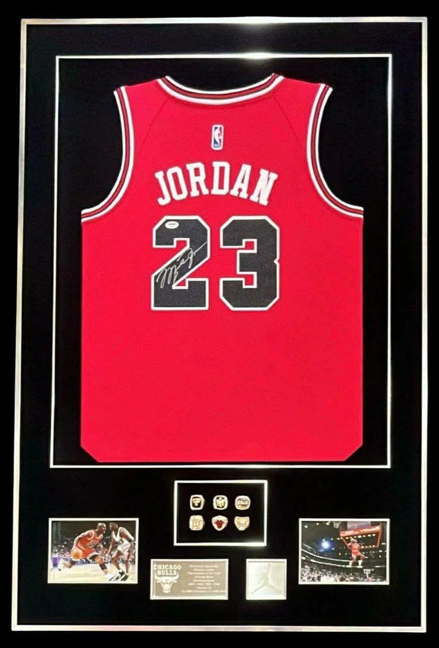 Michael Jordan — signed Chicago Bulls jersey with championship rings (gold frame) — authentic signed memorabilia, framed
