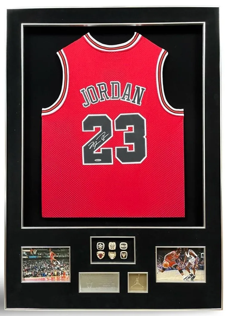 Michael Jordan — signed Chicago Bulls jersey with championship rings (silver frame) — authentic signed memorabilia, framed