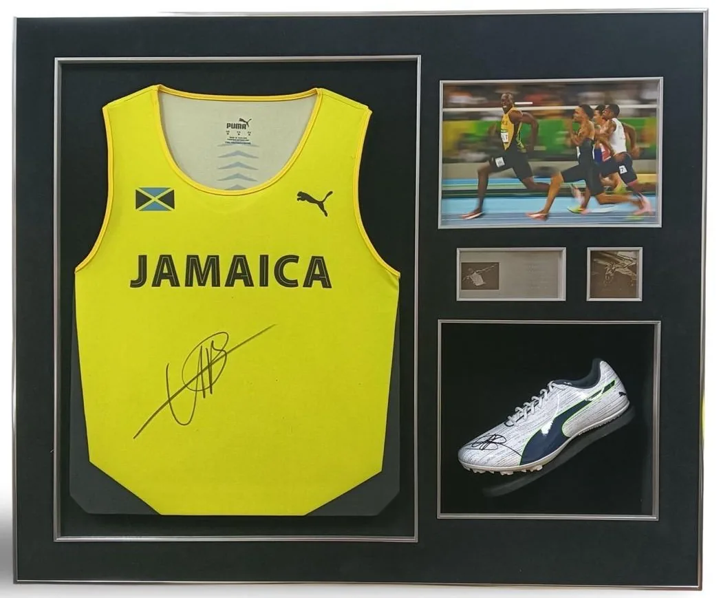 Usain Bolt — signed Jamaica vest and spike (race photo, silver frame) — authentic signed memorabilia, framed